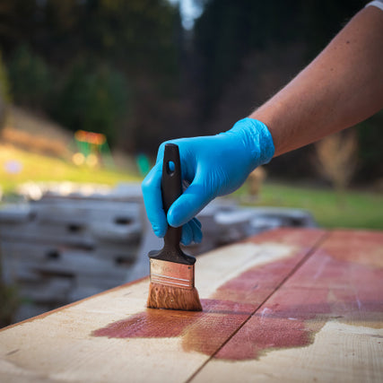 Exterior StainsA close up of wood being stained